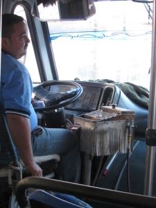 Notice the driver has his ticket pack and change box at his right hand.  He changes f=gear, opens and shuts the door, hands put tickets and receives and gives change while driving.
